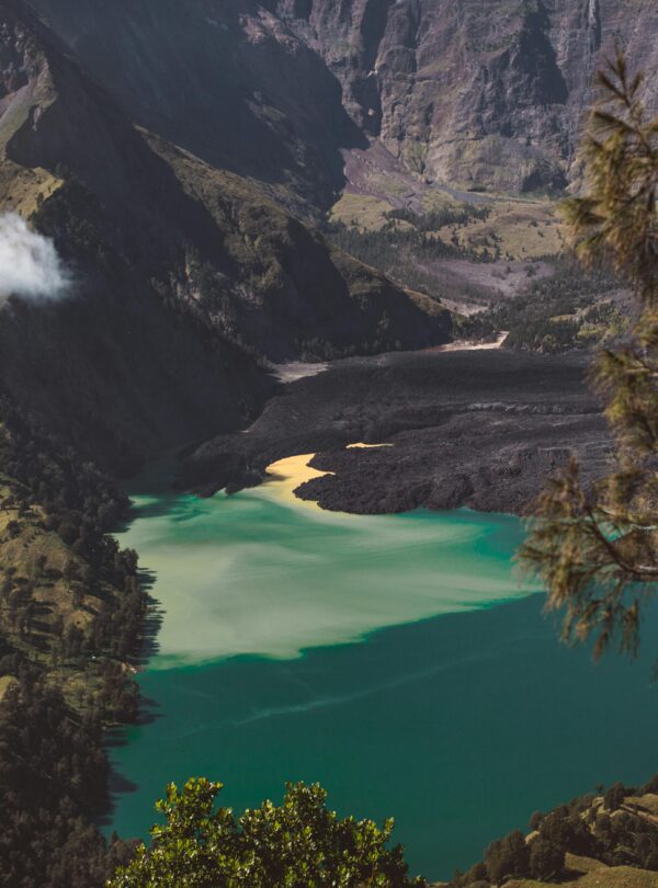 Picturesque turquoise Segara Anak lake located in volcano caldera and surrounded by rocky hills