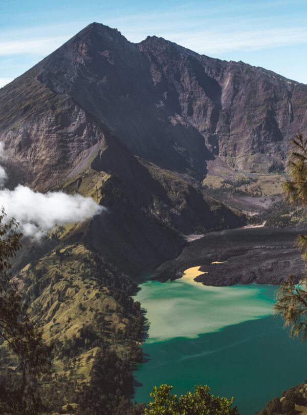Majestic mountain with clear blue lake under a cloudless sky, perfect for nature lovers.